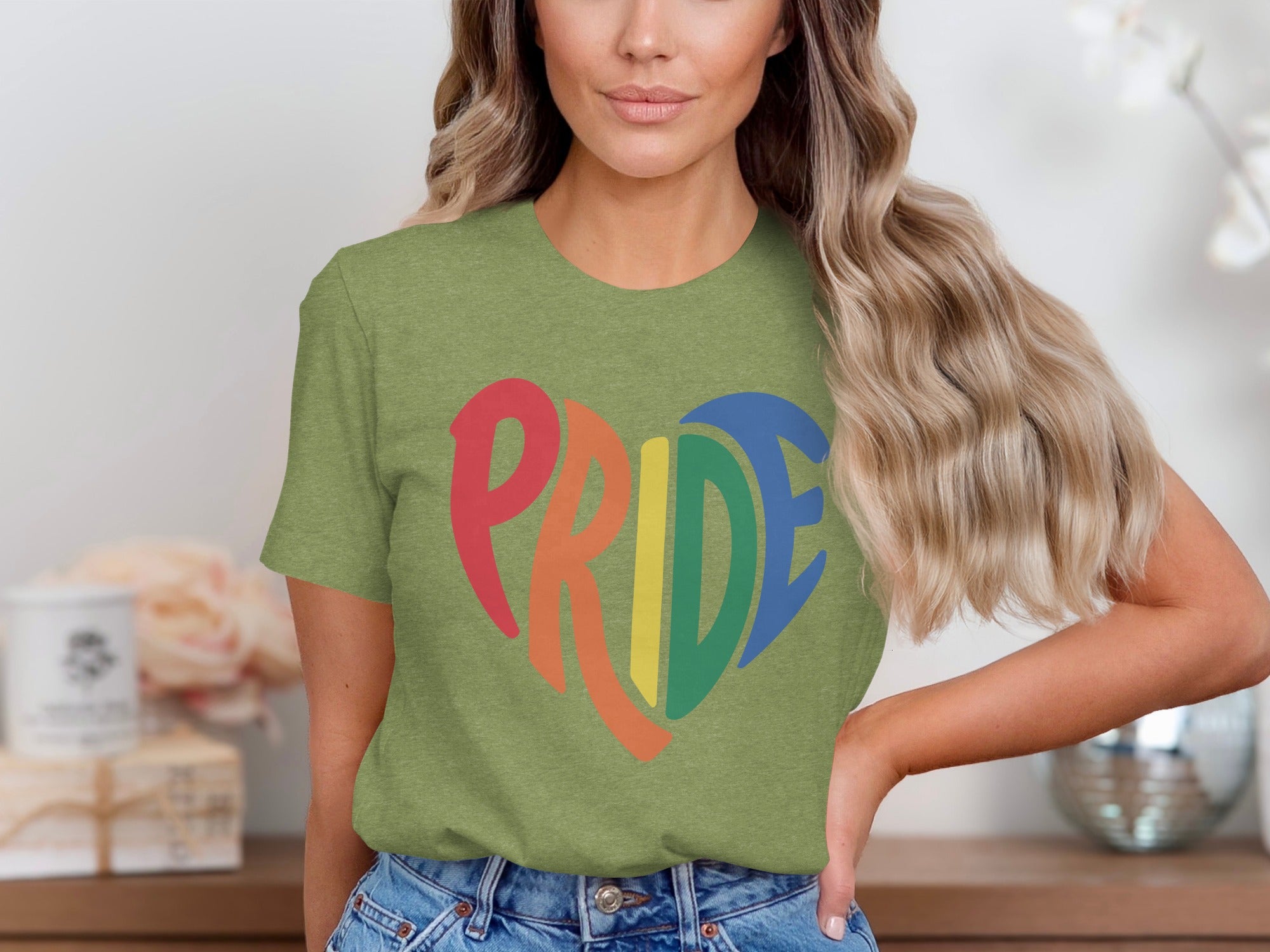 Green t-shirt with rainbow heart graphic spelling PRIDE.