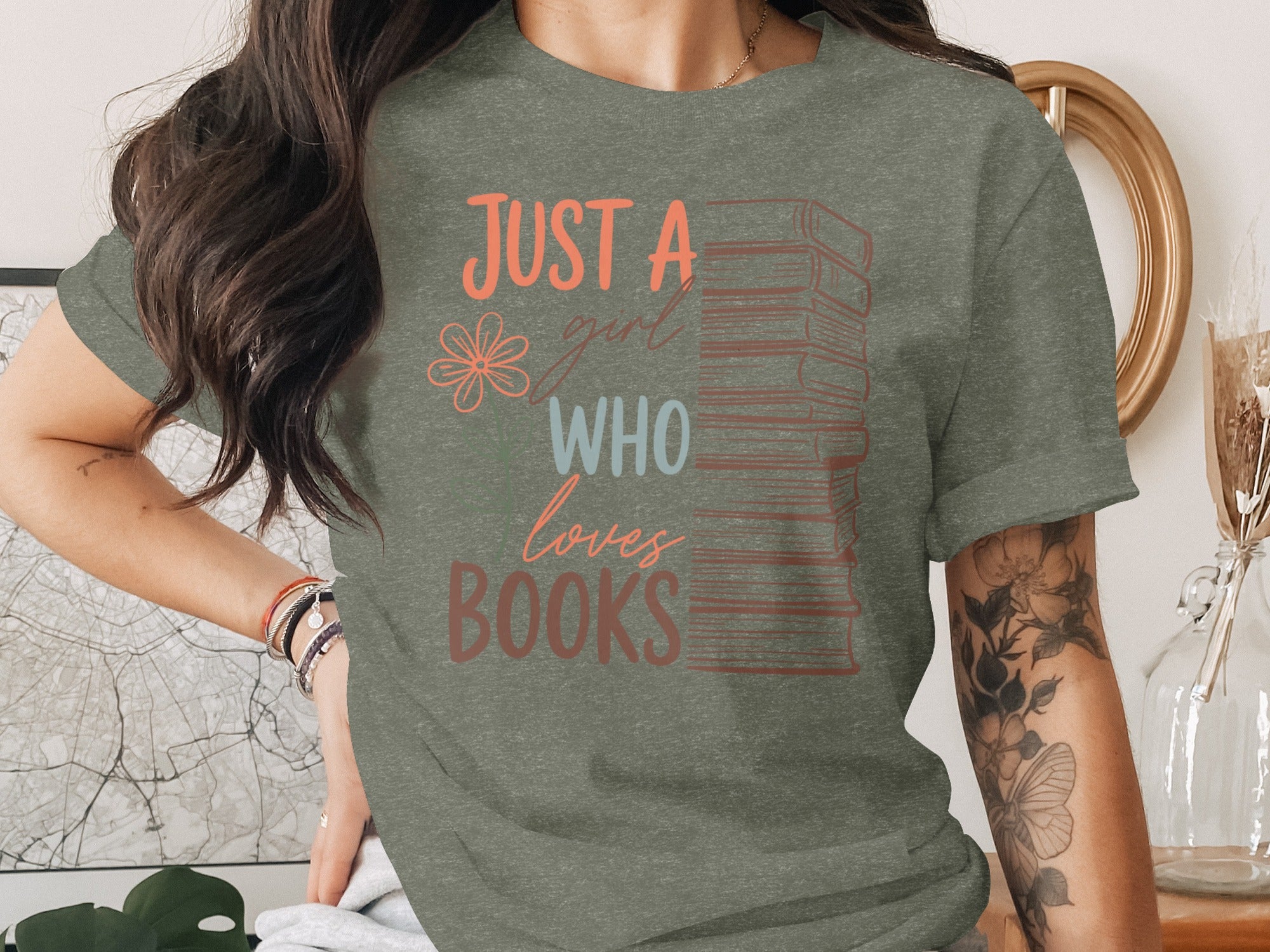 Green t-shirt with stacked books and text "JUST A girl WHO loves BOOKS".