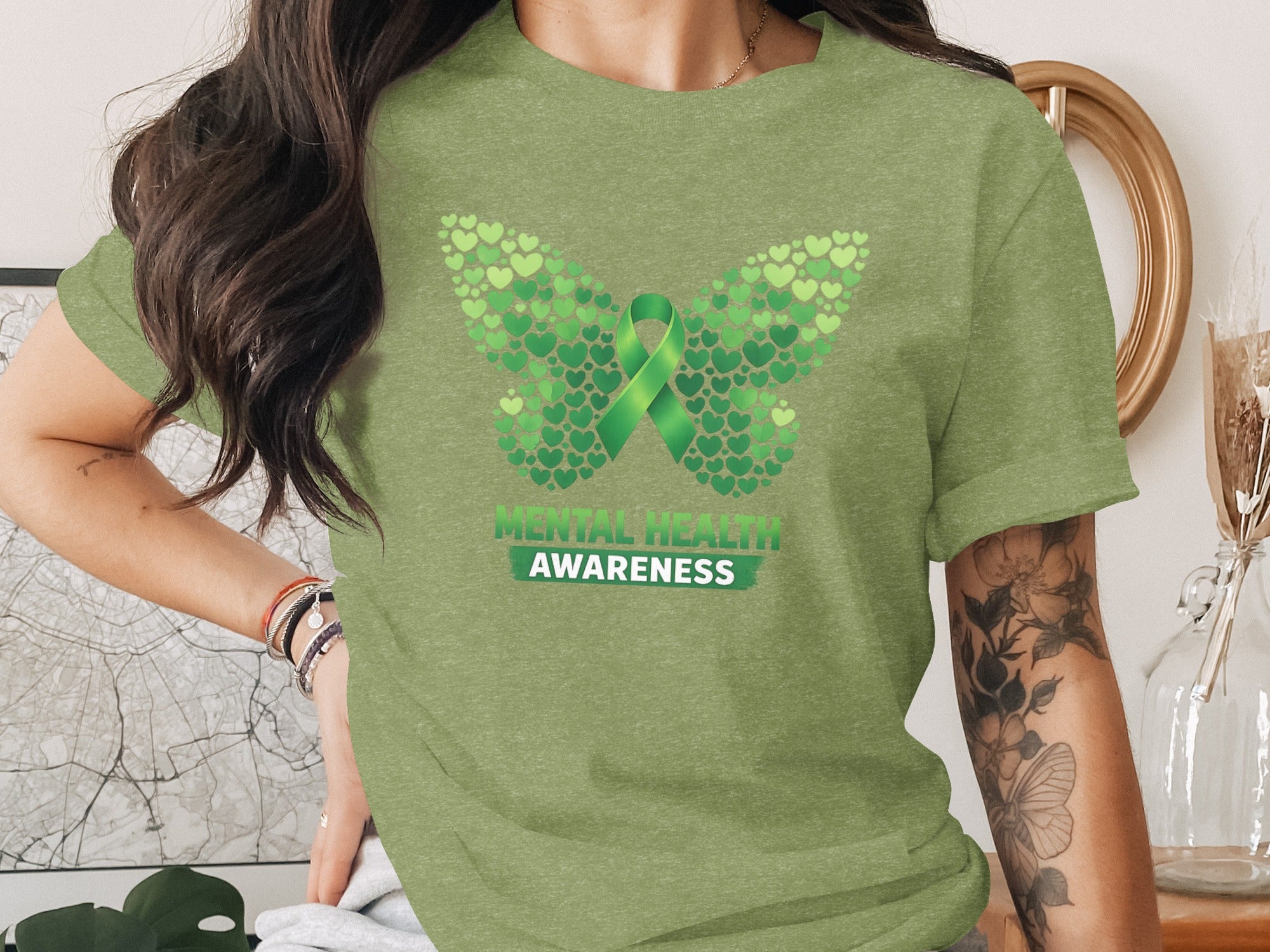 Green butterfly made of hearts with a green ribbon and text "Mental Health Awareness"