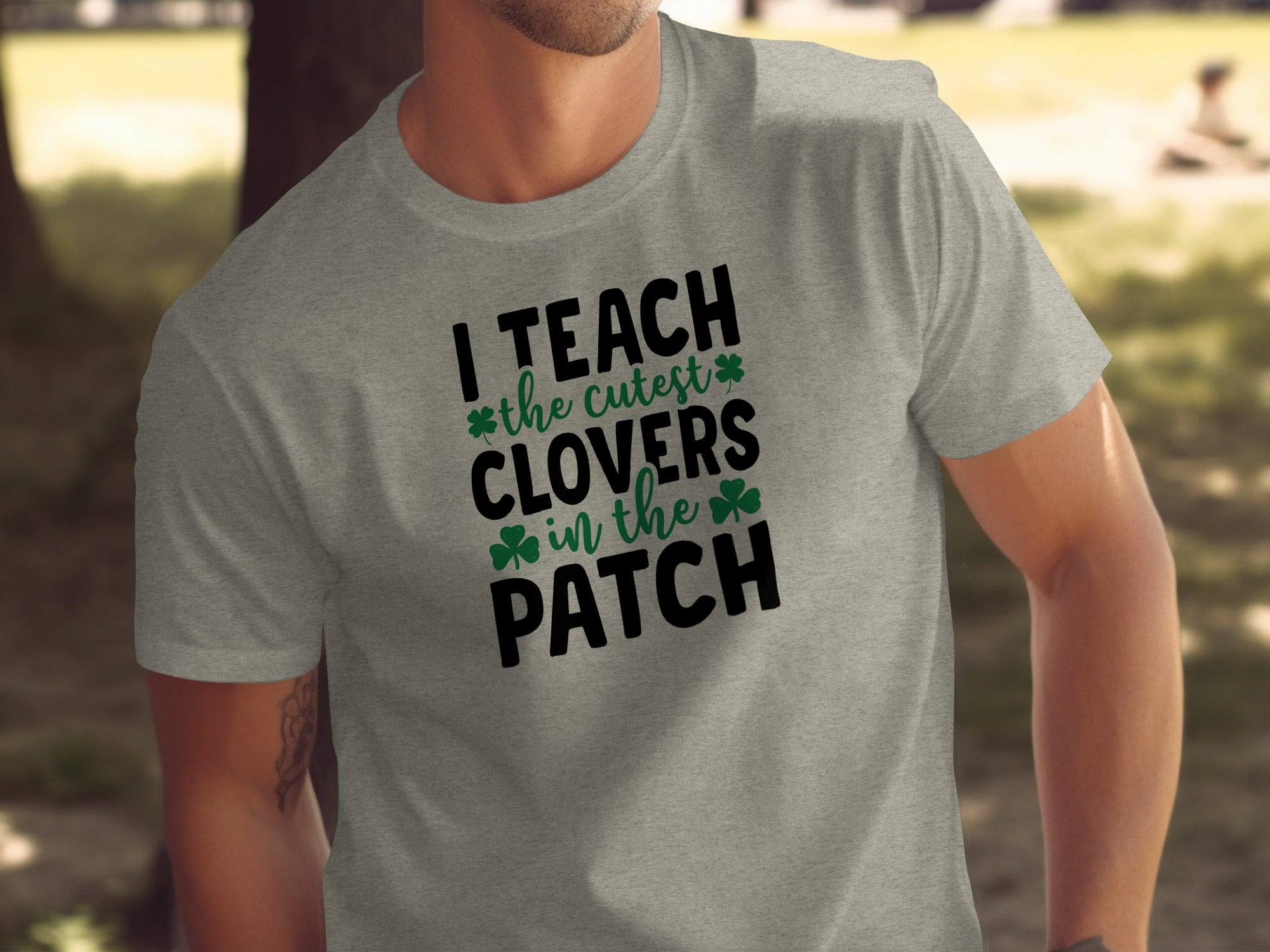 Grey t-shirt with black text that reads "I TEACH the cutest CLOVERS in the PATCH".
