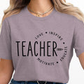 Graphic tee with "TEACHER" and "Love Inspire Motivate Educate" text design.