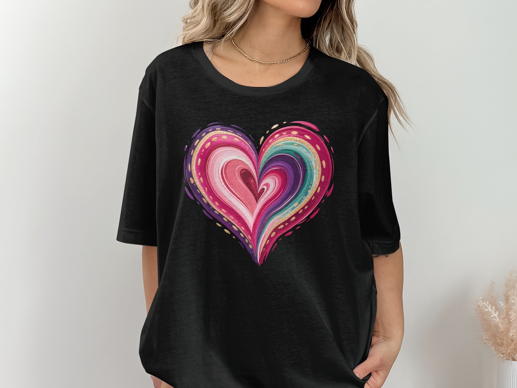Black t-shirt with a colorful abstract heart design featuring gold accents
