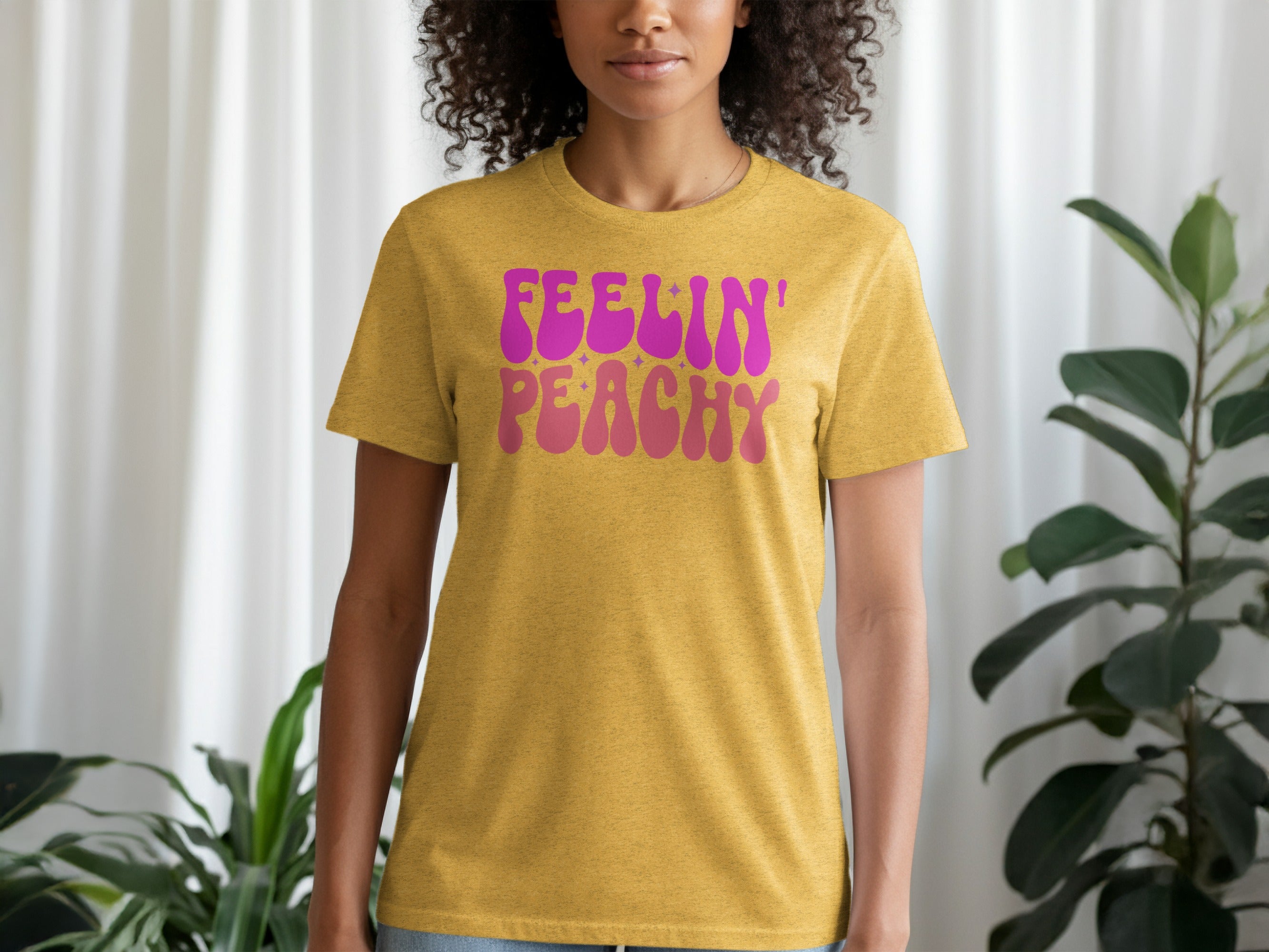 Gold t-shirt with pink and orange "Feelin' Peachy" text and stars.