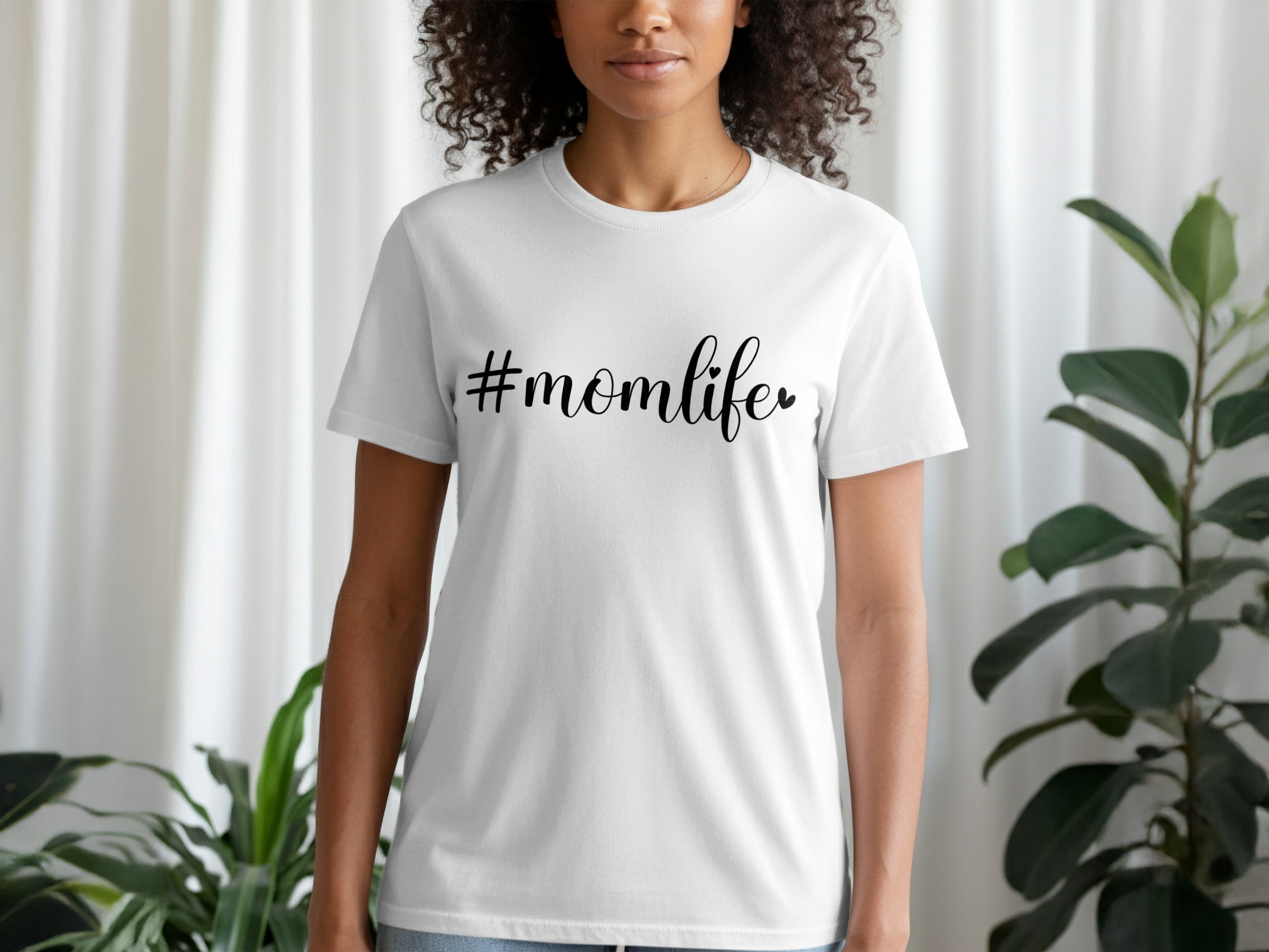 White t-shirt with "#momlife" text in black cursive font.