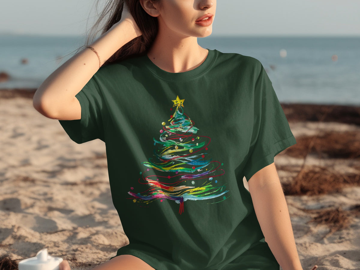 Green t-shirt with colorful abstract Christmas tree graphic on the chest.