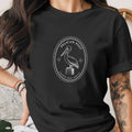 Black t-shirt with white oval logo featuring a pelican and text.