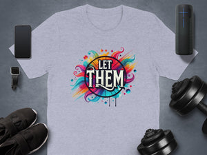 Light grey t-shirt with colorful "LET THEM" graphic and surrounding abstract elements.