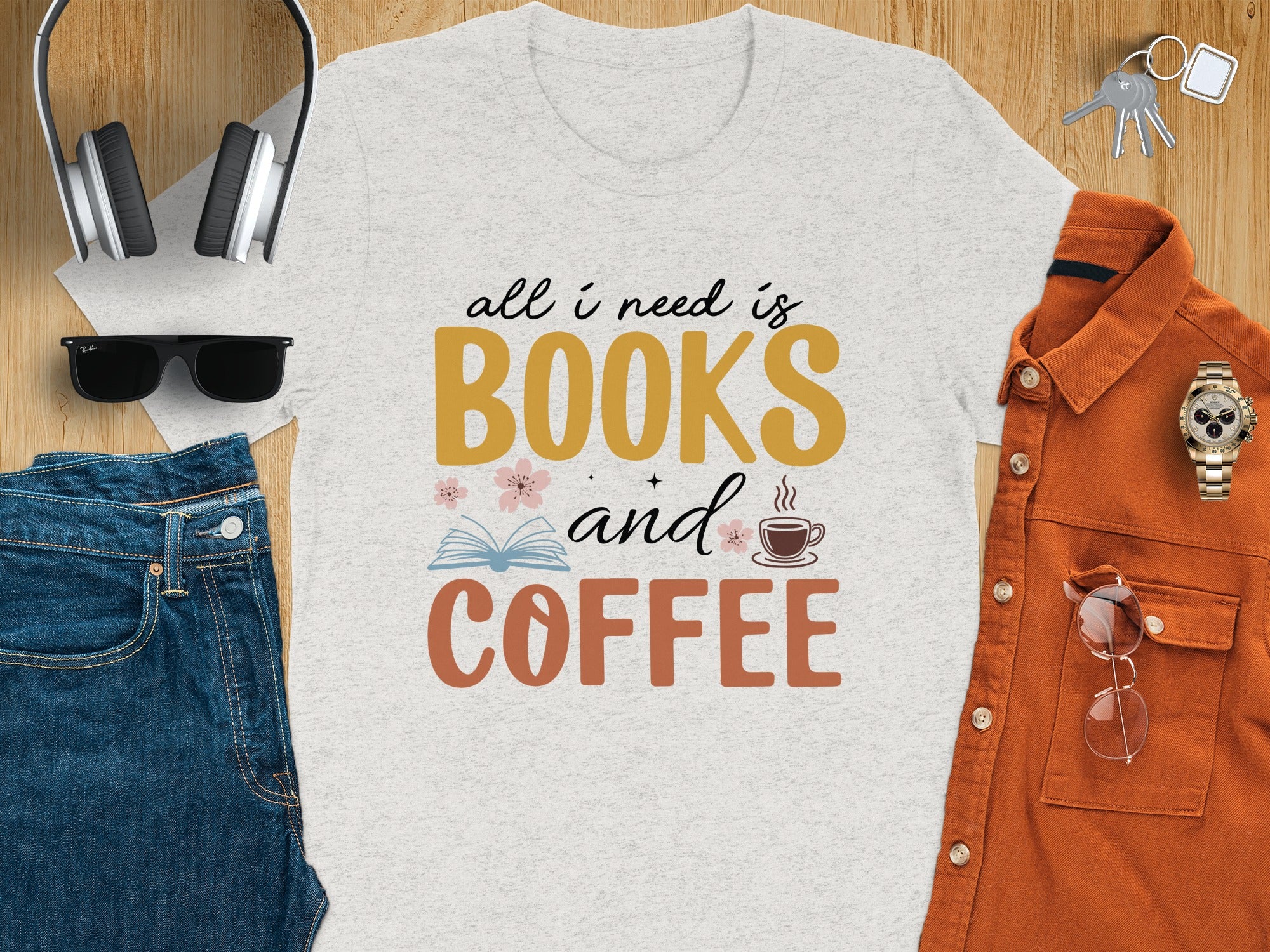 "All I need is Books and Coffee" text on light grey t-shirt with accessories