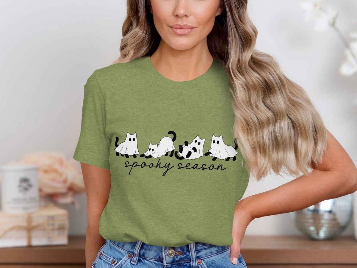 Green t-shirt with black ghost cats and "spooky season" text.
