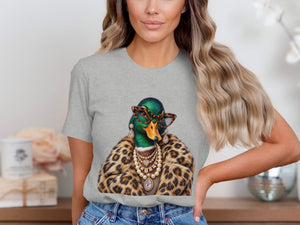 Duck wearing glasses, pearls, and a leopard print coat on a grey t-shirt.