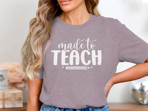 Purple t-shirt with white text "made to TEACH" and a pencil graphic.