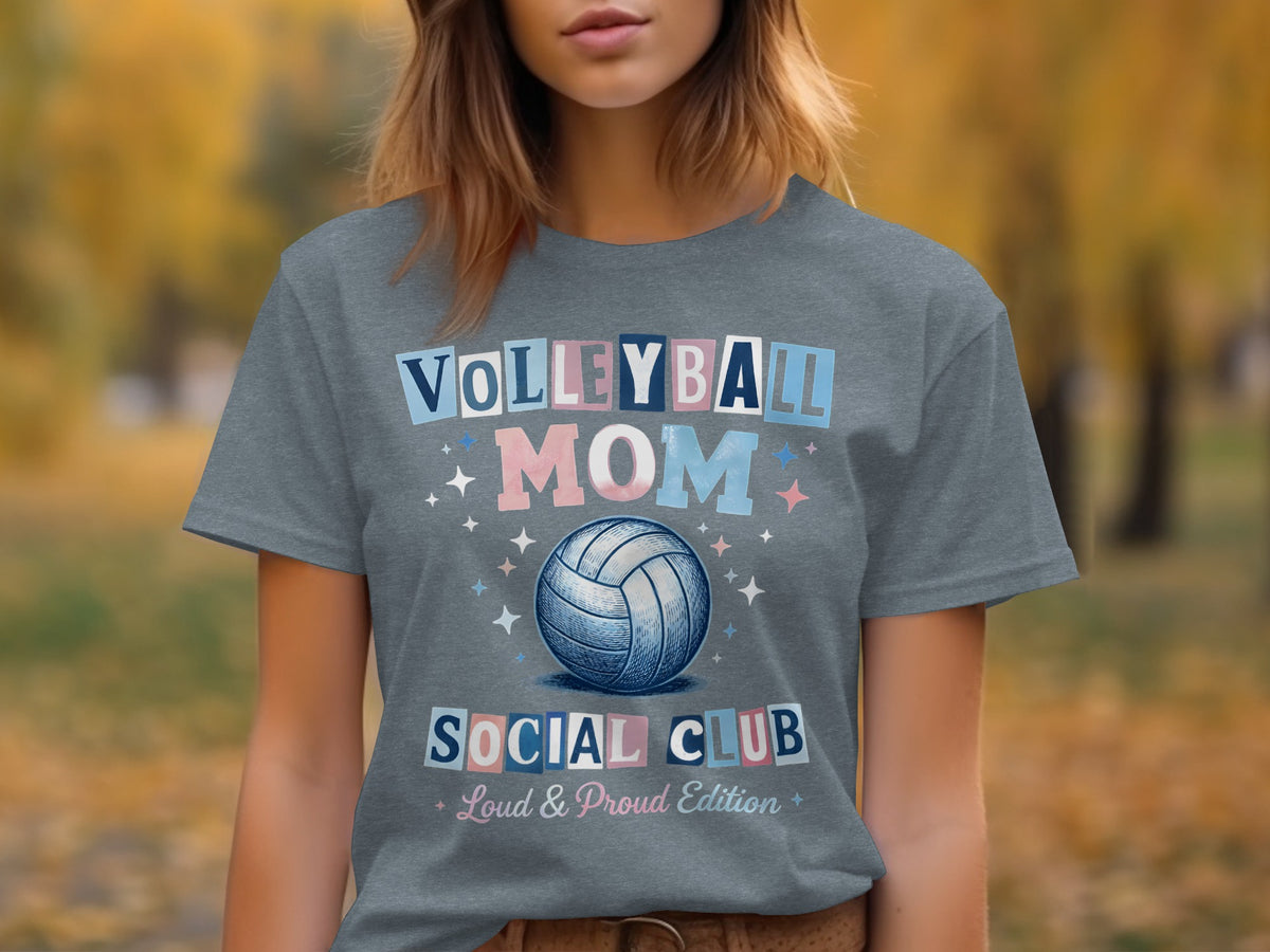 A woman wears a gray t-shirt featuring Volleyball Mom Social Club text and a volleyball graphic.