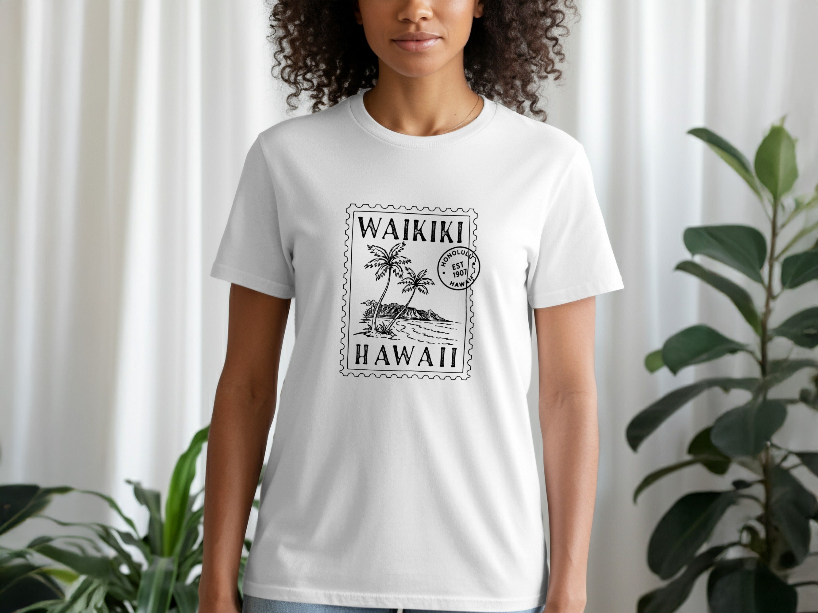 White t-shirt with a postage stamp graphic featuring palm trees and "Waikiki Hawaii" text.