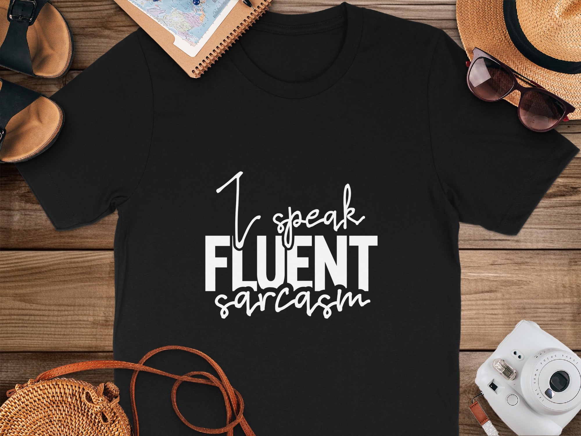 Black t-shirt with white text that reads "I speak FLUENT sarcasm".