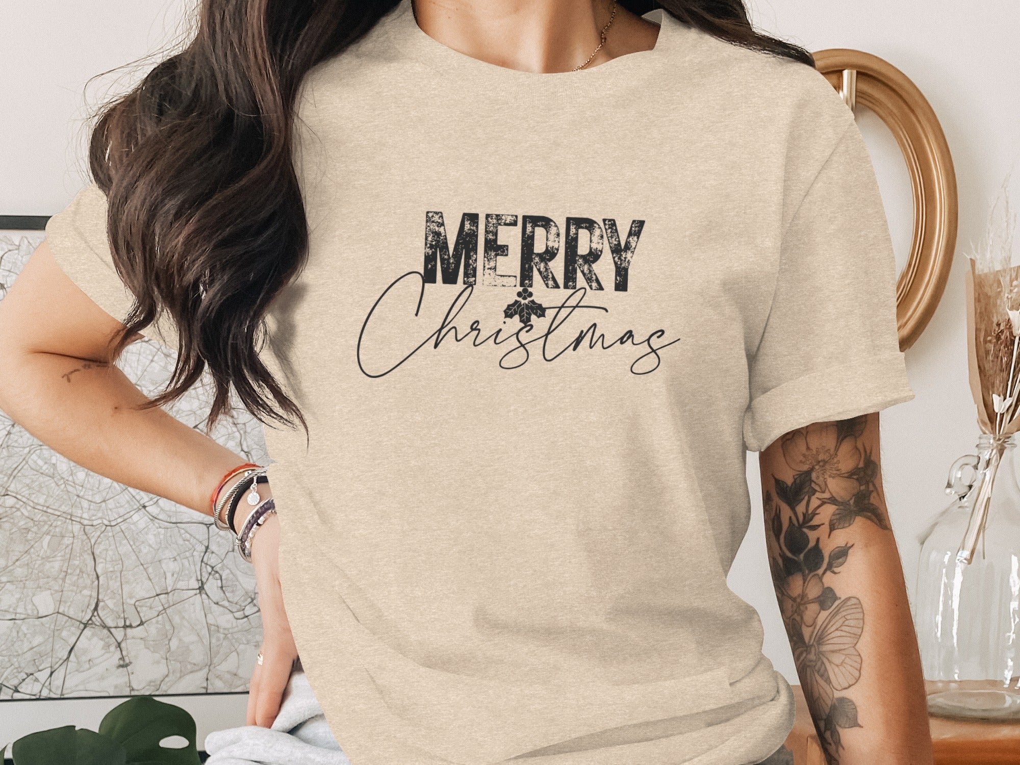 T-shirt with "MERRY Christmas" text and a holly leaf accent.