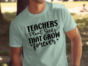 Light mint t-shirt with black text and floral graphics reading "TEACHERS Plant Seeds THAT GROW forever"