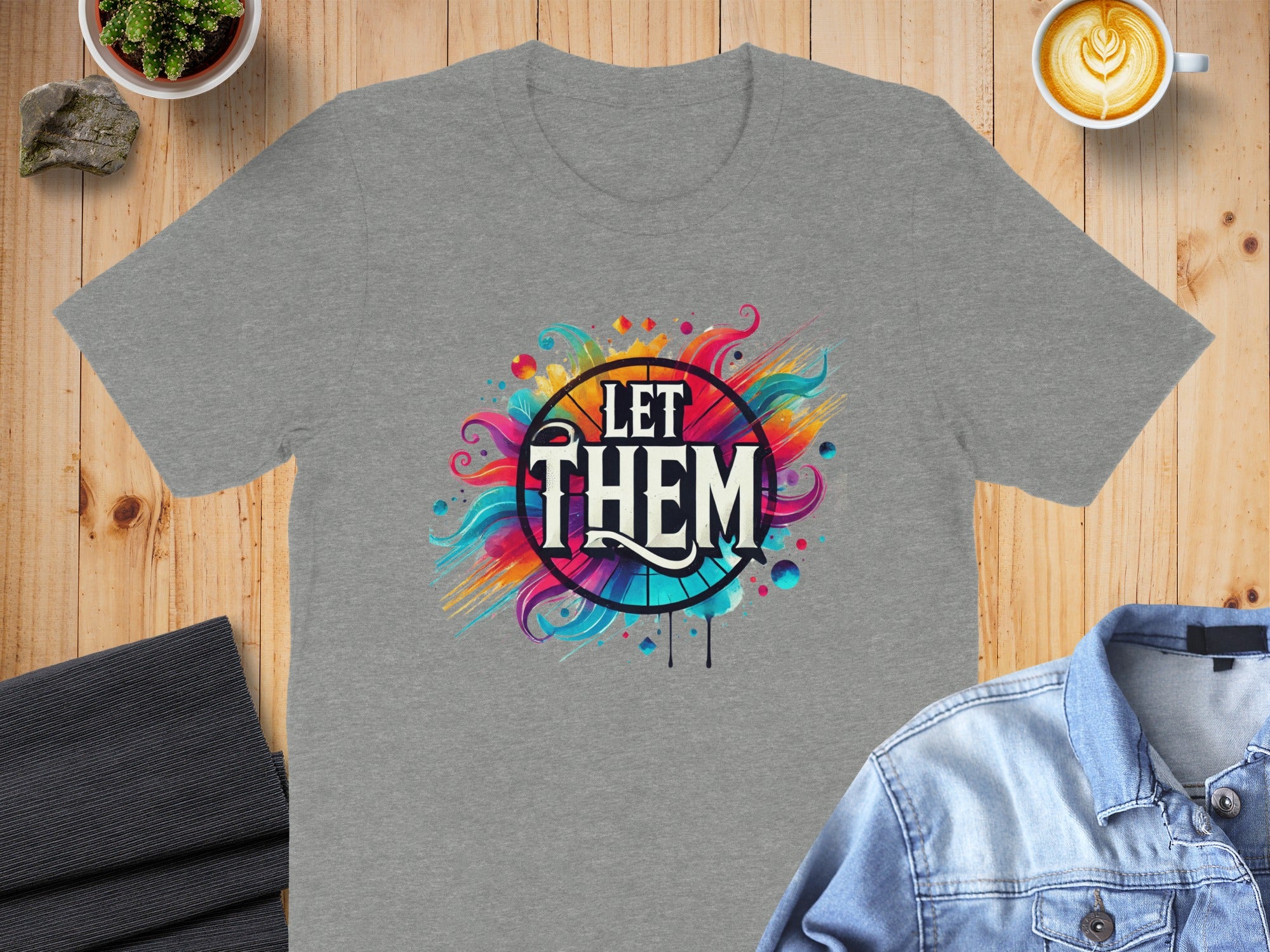 Grey t-shirt with "LET THEM" text and colorful abstract design.