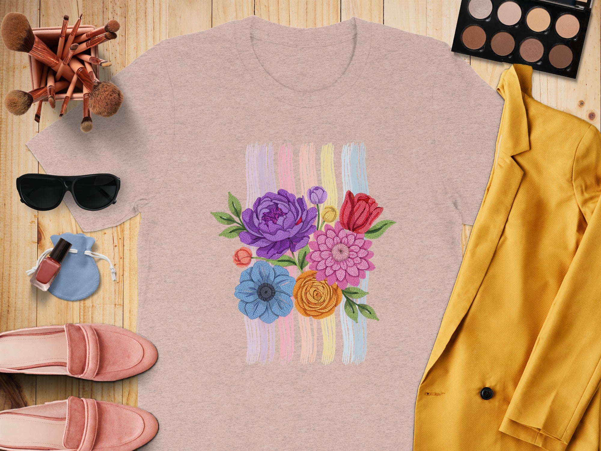Pink t-shirt with embroidered floral bouquet and pastel brushstrokes.