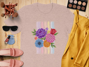 Pink t-shirt with embroidered floral bouquet and pastel brushstrokes.
