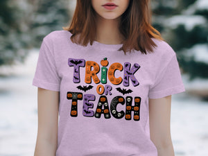 Purple t-shirt with "Trick or Teach" Halloween graphic featuring pumpkins and bats.