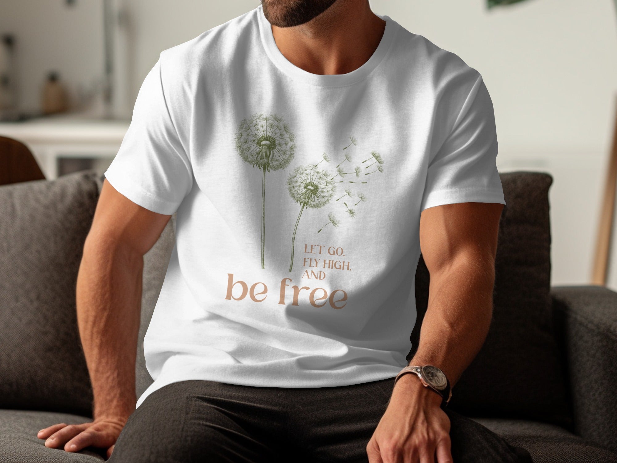 White t-shirt with dandelion graphic and "Let go, fly high, and be free" text.