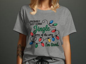 Grey t-shirt with Christmas lights and text "Probably Just Gonna Jingle Some Of The Way. I'm Tired."