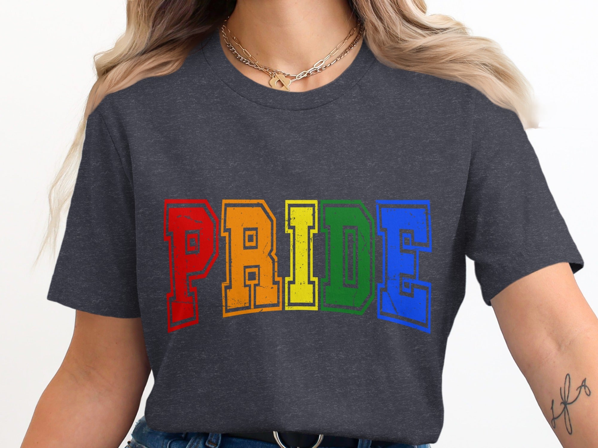 Dark gray t-shirt with "PRIDE" in rainbow varsity letters.