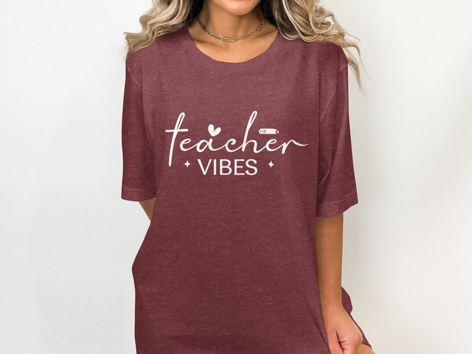 Maroon t-shirt with white text reading "teacher VIBES" and graphic elements.