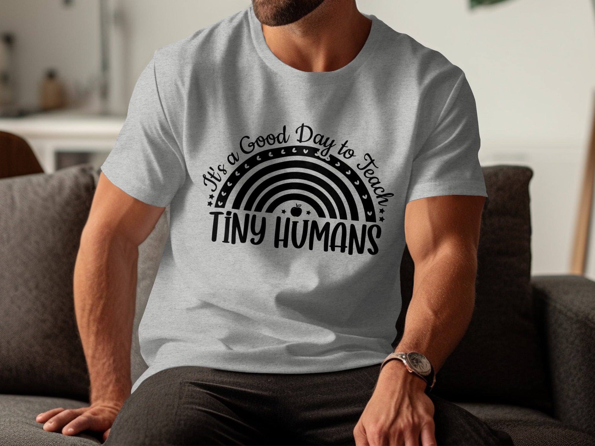 Gray t-shirt with "It's a Good Day to Teach TINY HUMANS" text and rainbow graphic.
