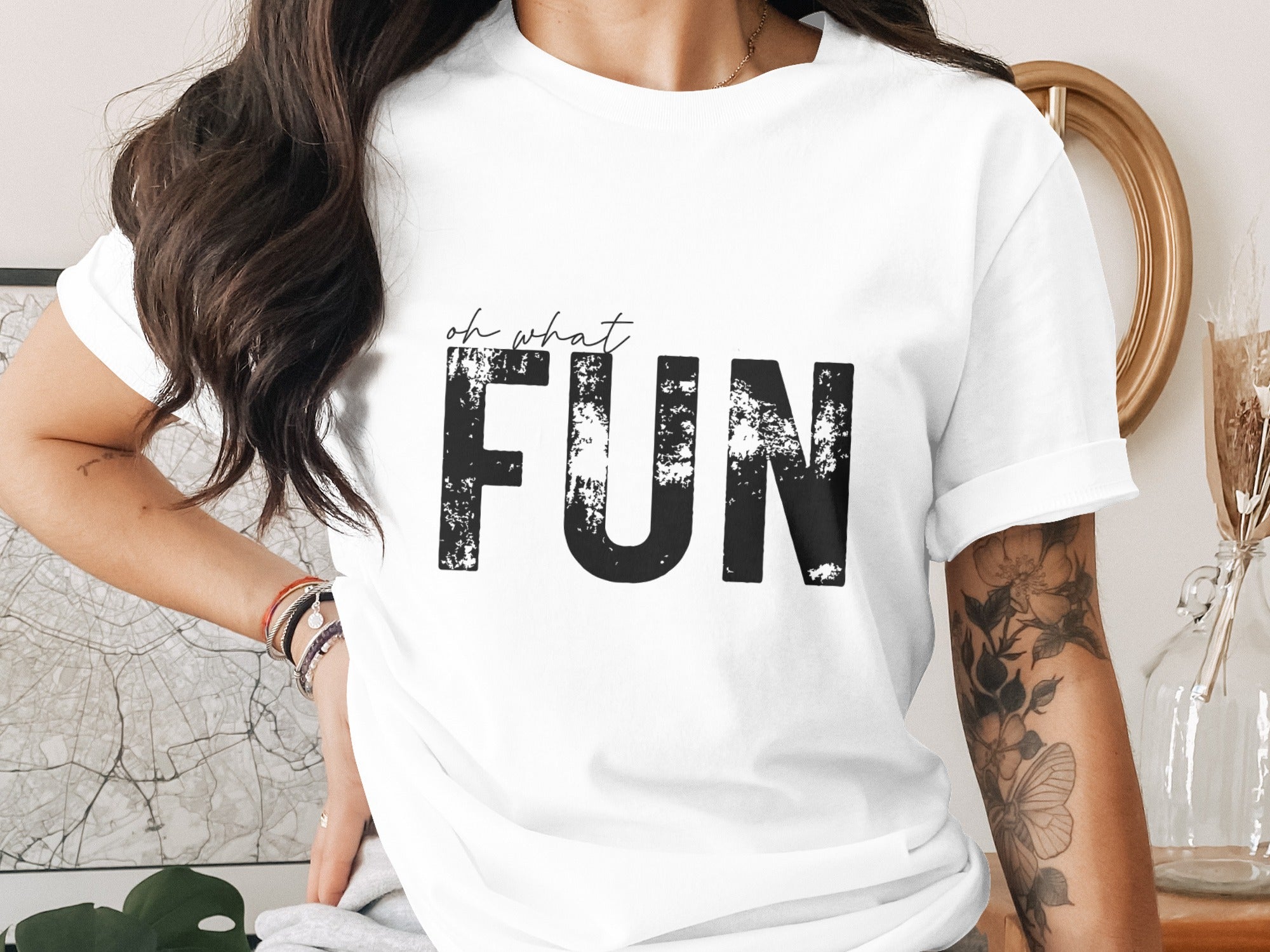 White t-shirt with black text "oh what FUN" and distressed lettering.