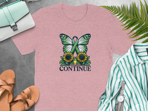 Pink t-shirt with butterfly, sunflowers, green ribbon, and text "CONTINUE".