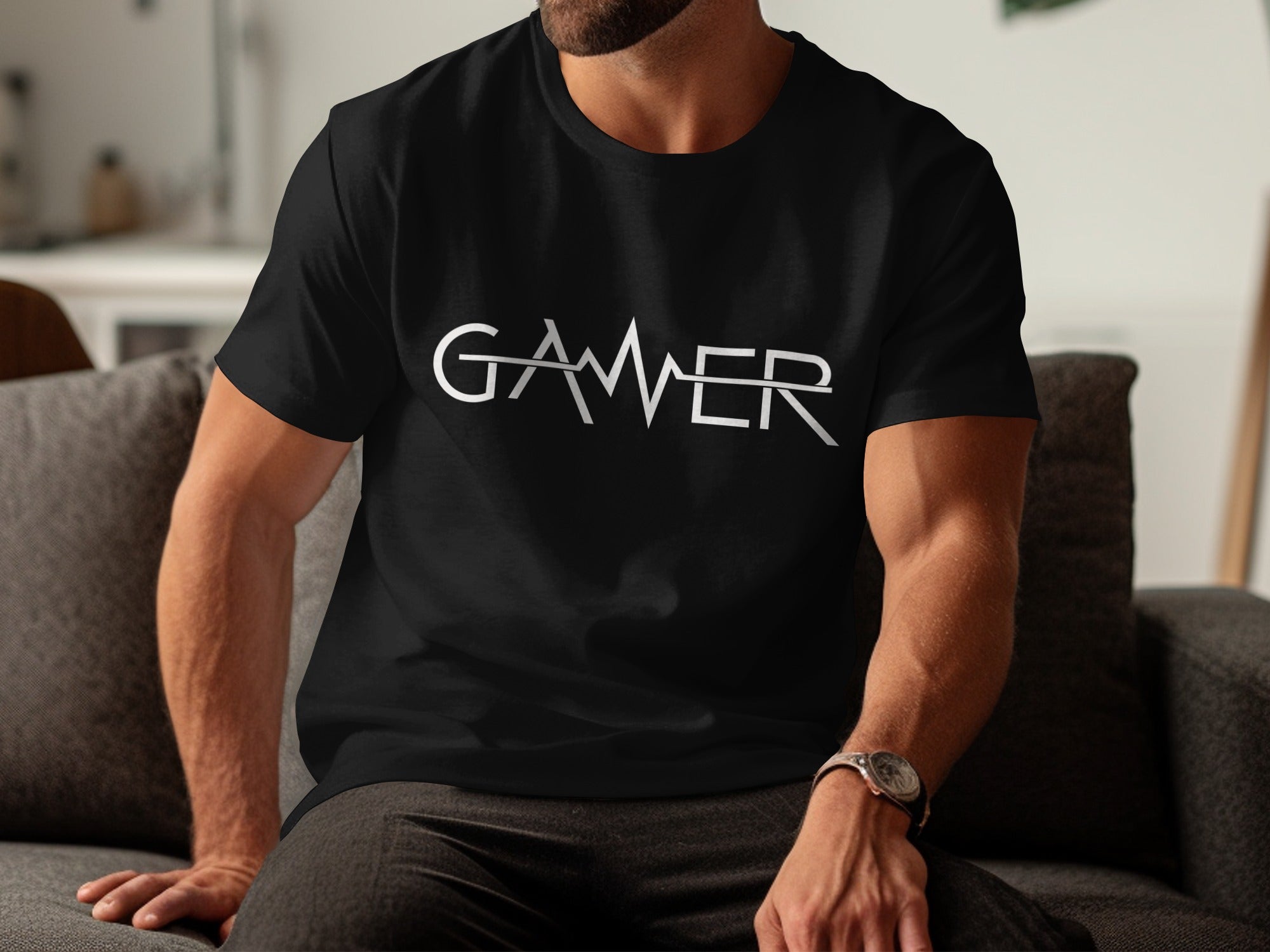 Black t-shirt with white text spelling "GAMER" with a stylized line through the middle.