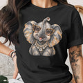 Black t-shirt with a stylized elephant wearing leopard print glasses and a diamond necklace.