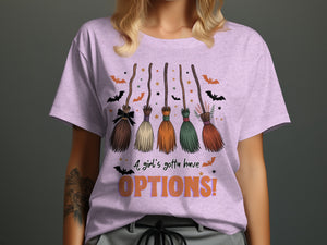 Purple t-shirt with five brooms, bats, stars, and text "A girl's gotta have OPTIONS!".