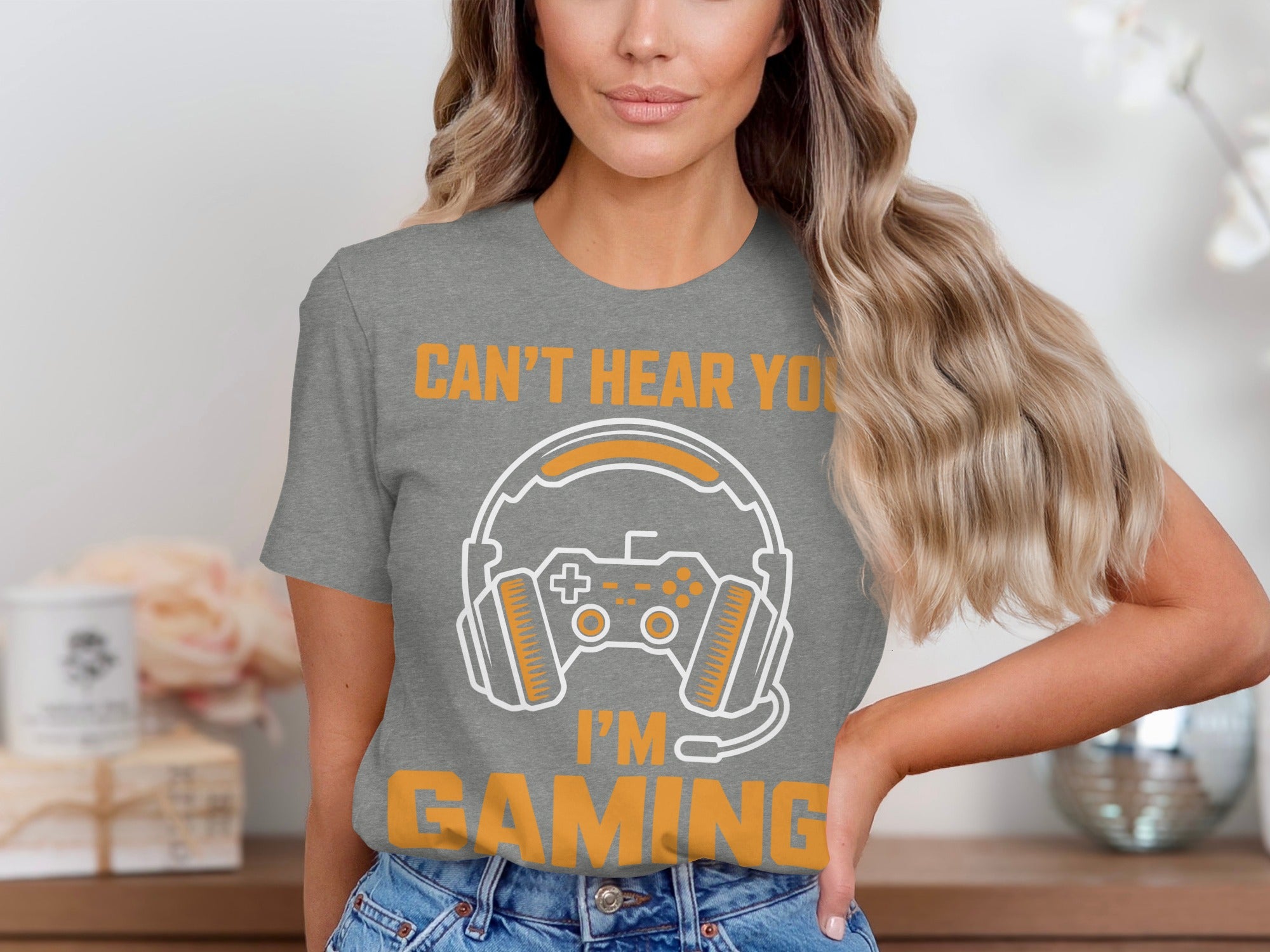 Grey t-shirt with orange text "CAN'T HEAR YOU I'M GAMING" and gaming graphics.