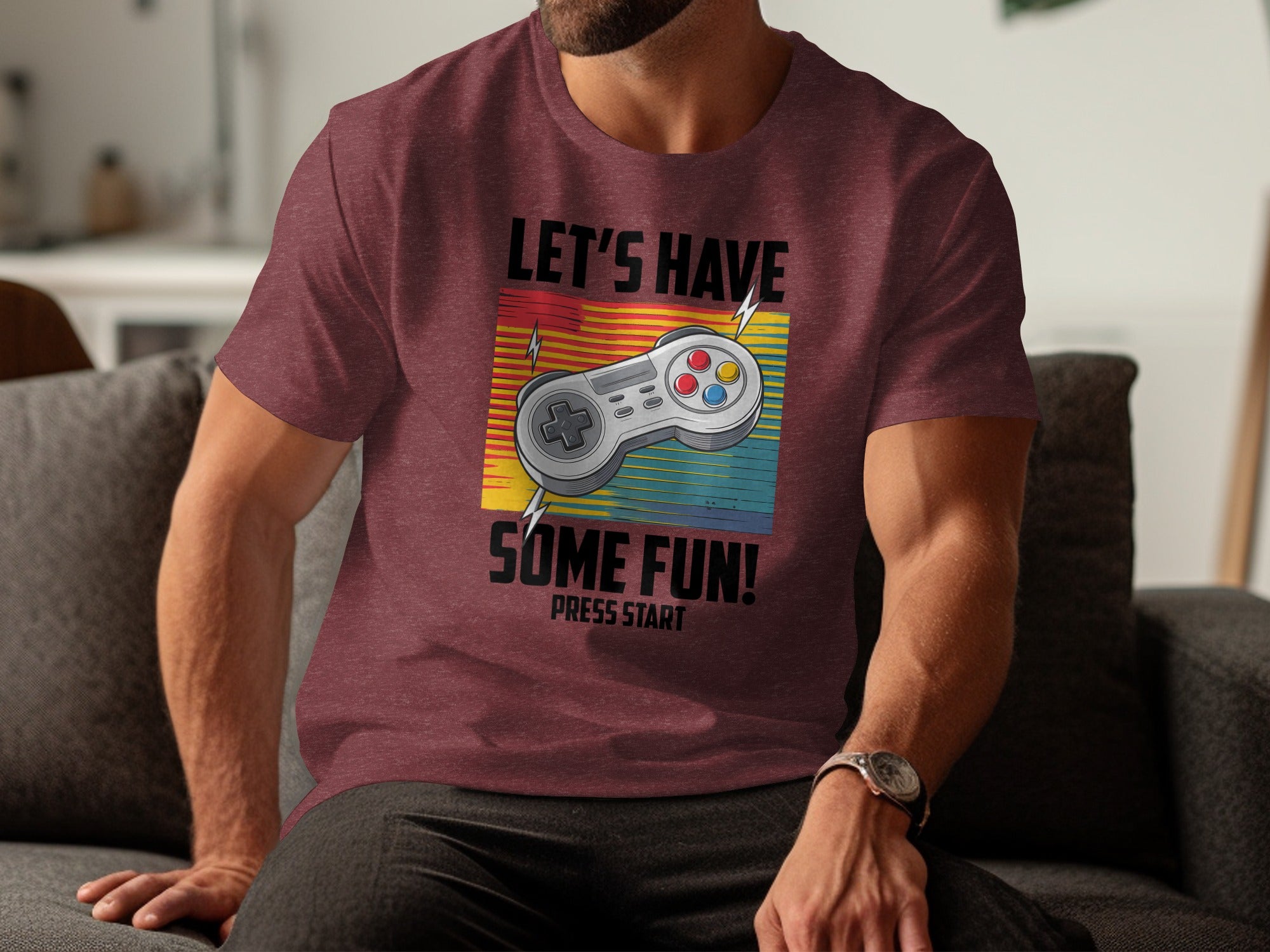 Maroon t-shirt with gaming controller and text "Let's Have Some Fun! Press Start."