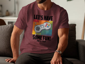 Maroon t-shirt with gaming controller and text "Let's Have Some Fun! Press Start."