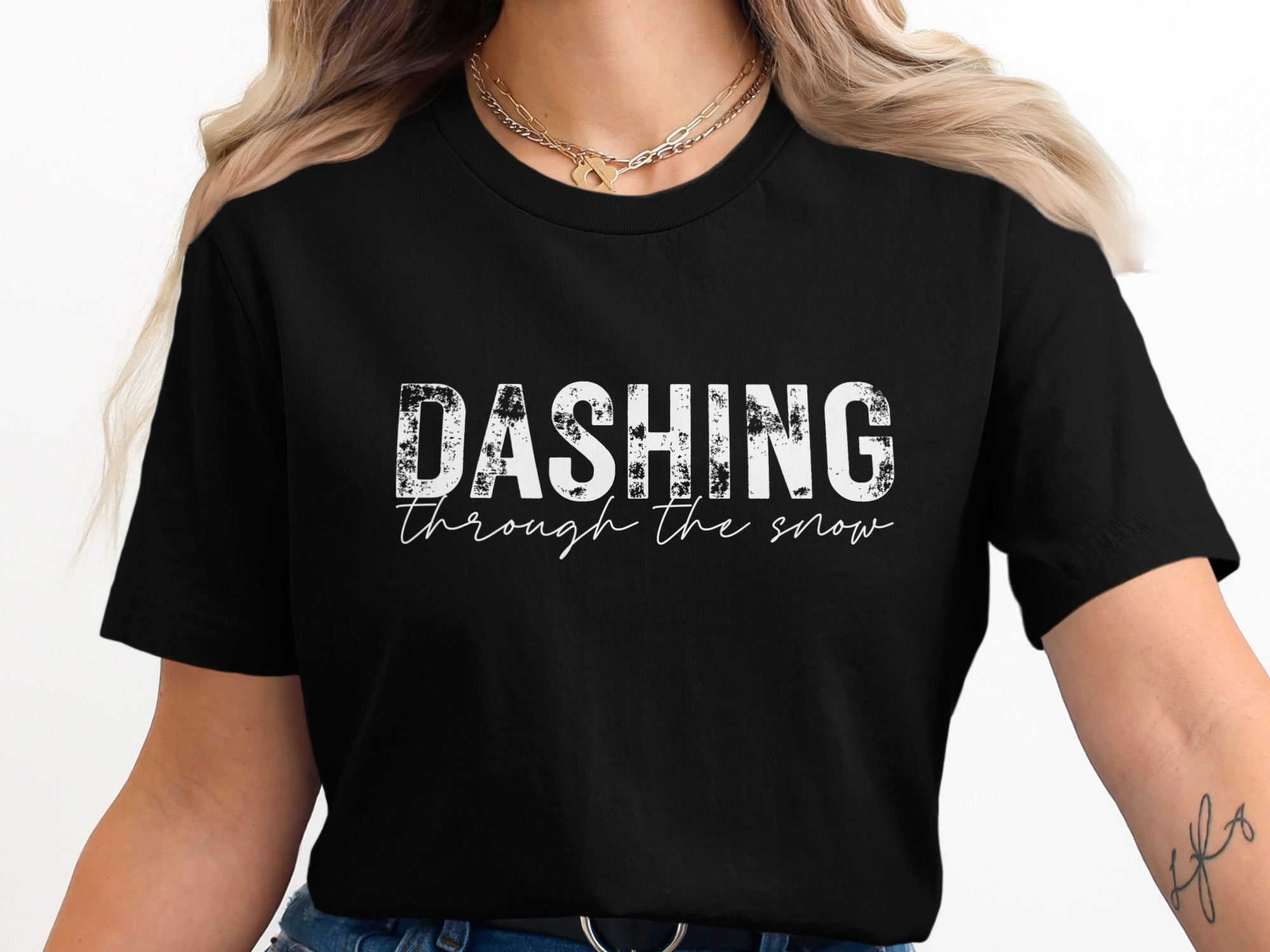 Black t-shirt with white text reading "DASHING through the snow."
