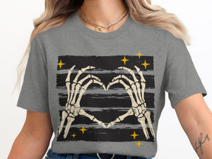 Skeleton hands form a heart over black and gray stripes with yellow stars.