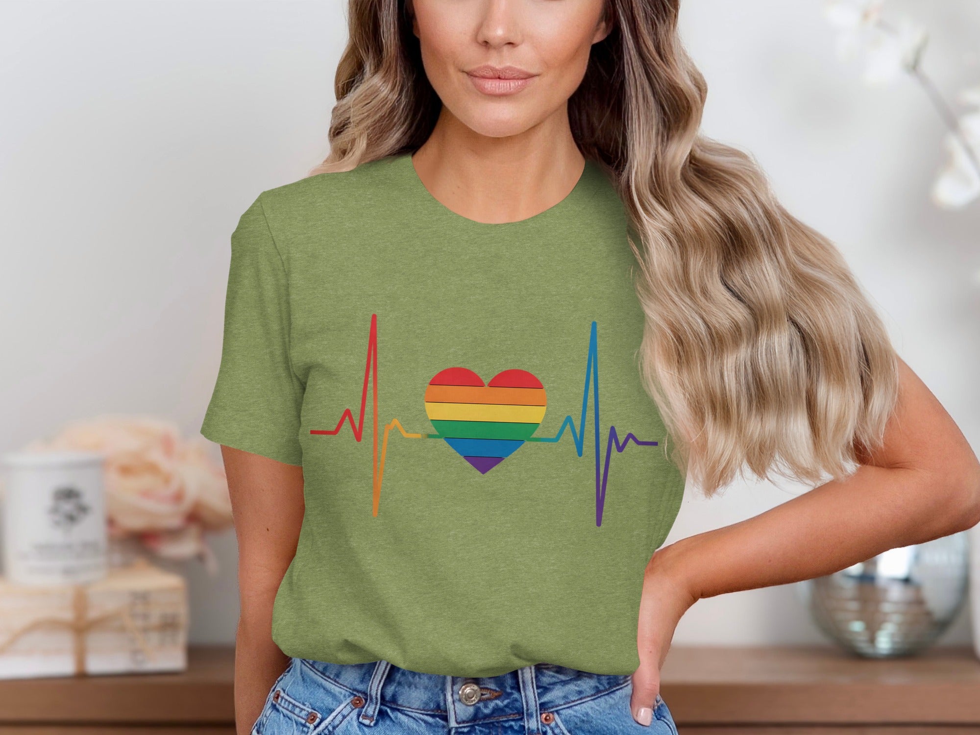 Green t-shirt with rainbow heart and heartbeat graphic.