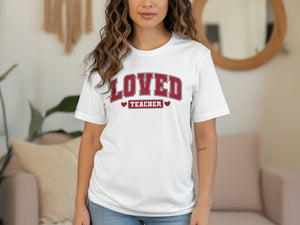White t-shirt with "Loved Teacher" text in distressed maroon collegiate lettering.