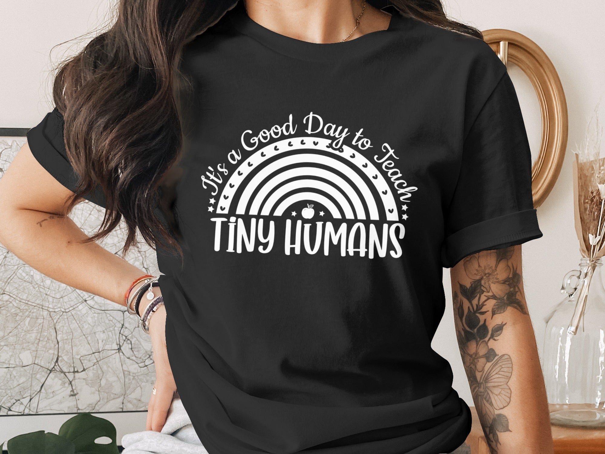 Black t-shirt with white text and rainbow graphic reading "It's a Good Day to Teach TINY HUMANS".