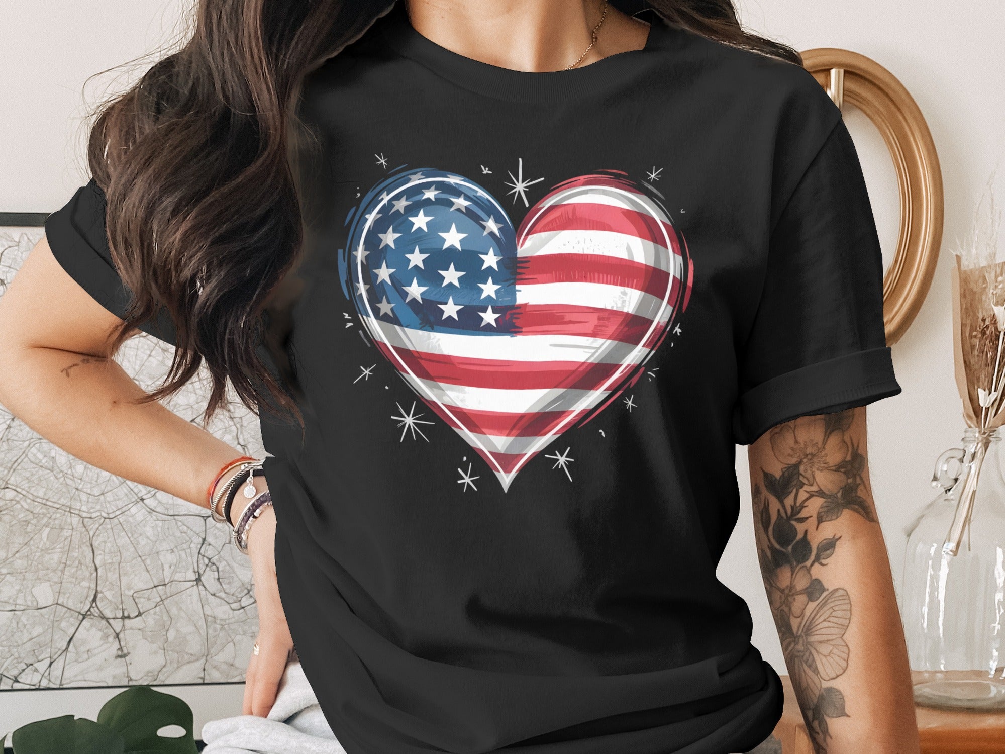 Black t-shirt with an American flag heart graphic and decorative stars.