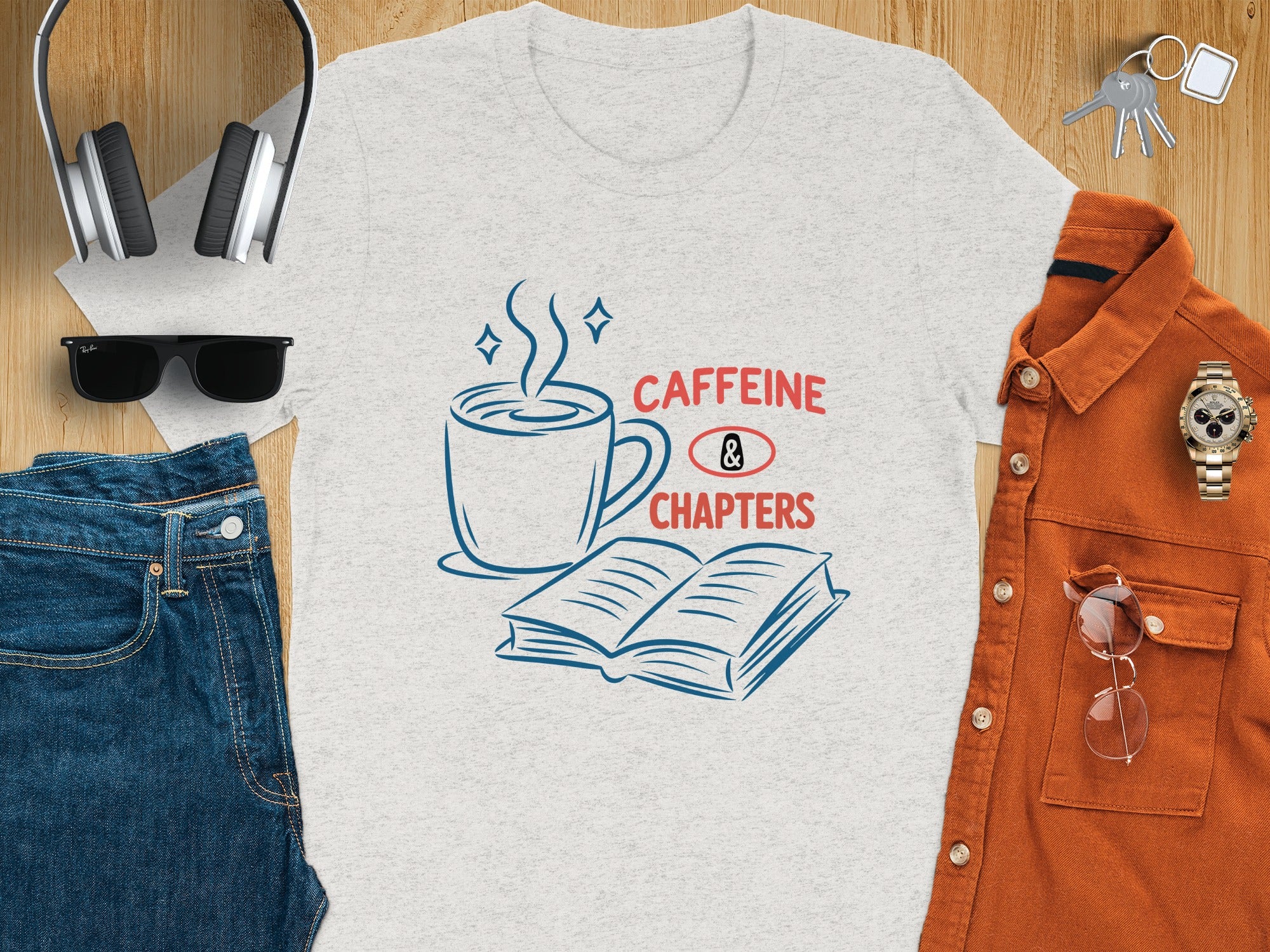 Grey t-shirt with "Caffeine & Chapters" text, coffee cup, and open book graphic.