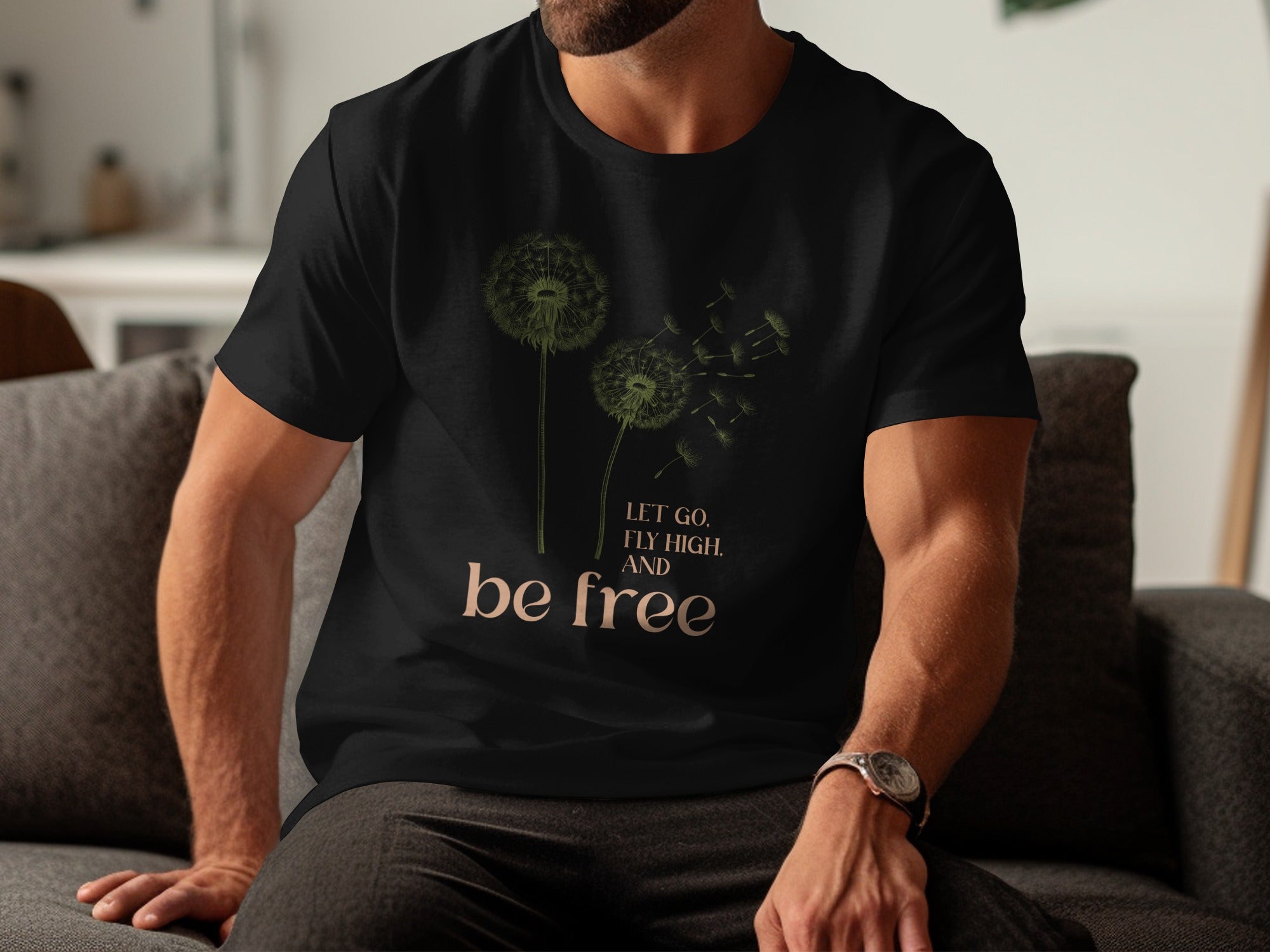 Black t-shirt with dandelion design and text "LET GO, FLY HIGH, AND be free."