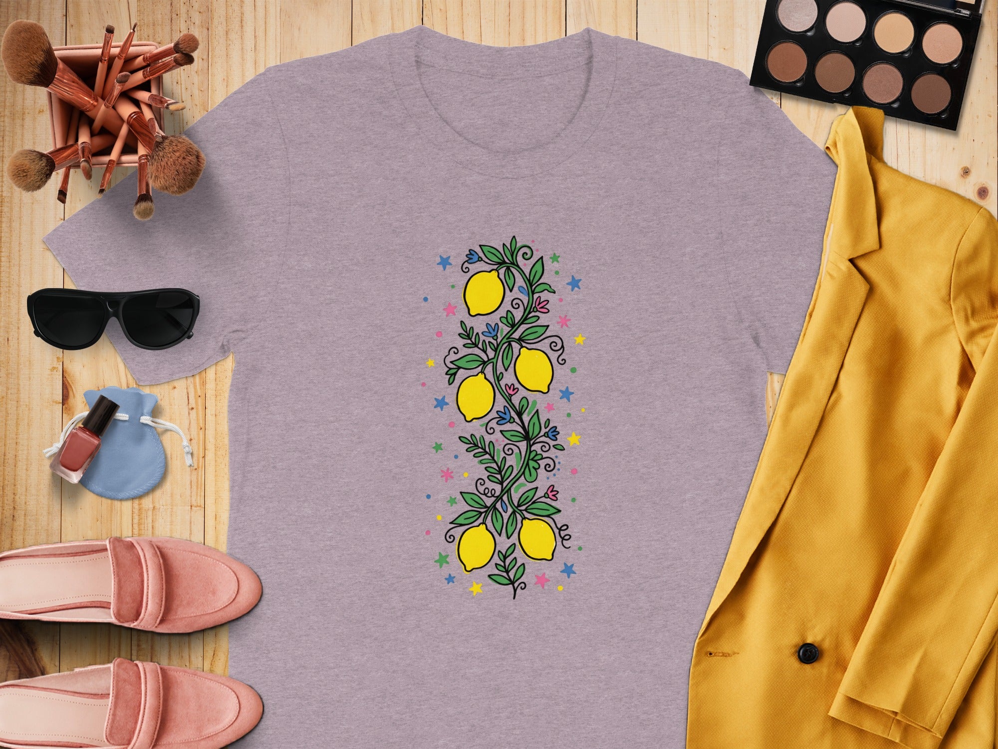 Purple t-shirt with a vertical lemon branch design and colorful stars and flowers.