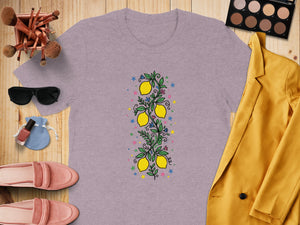Purple t-shirt with a vertical lemon branch design and colorful stars and flowers.