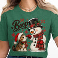 Christmas graphic with "Boop" text, snowman, and kitten on green shirt.