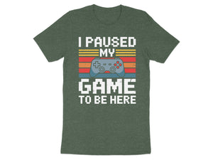 Dark green t-shirt with white text "I PAUSED MY GAME TO BE HERE" and a video game controller.