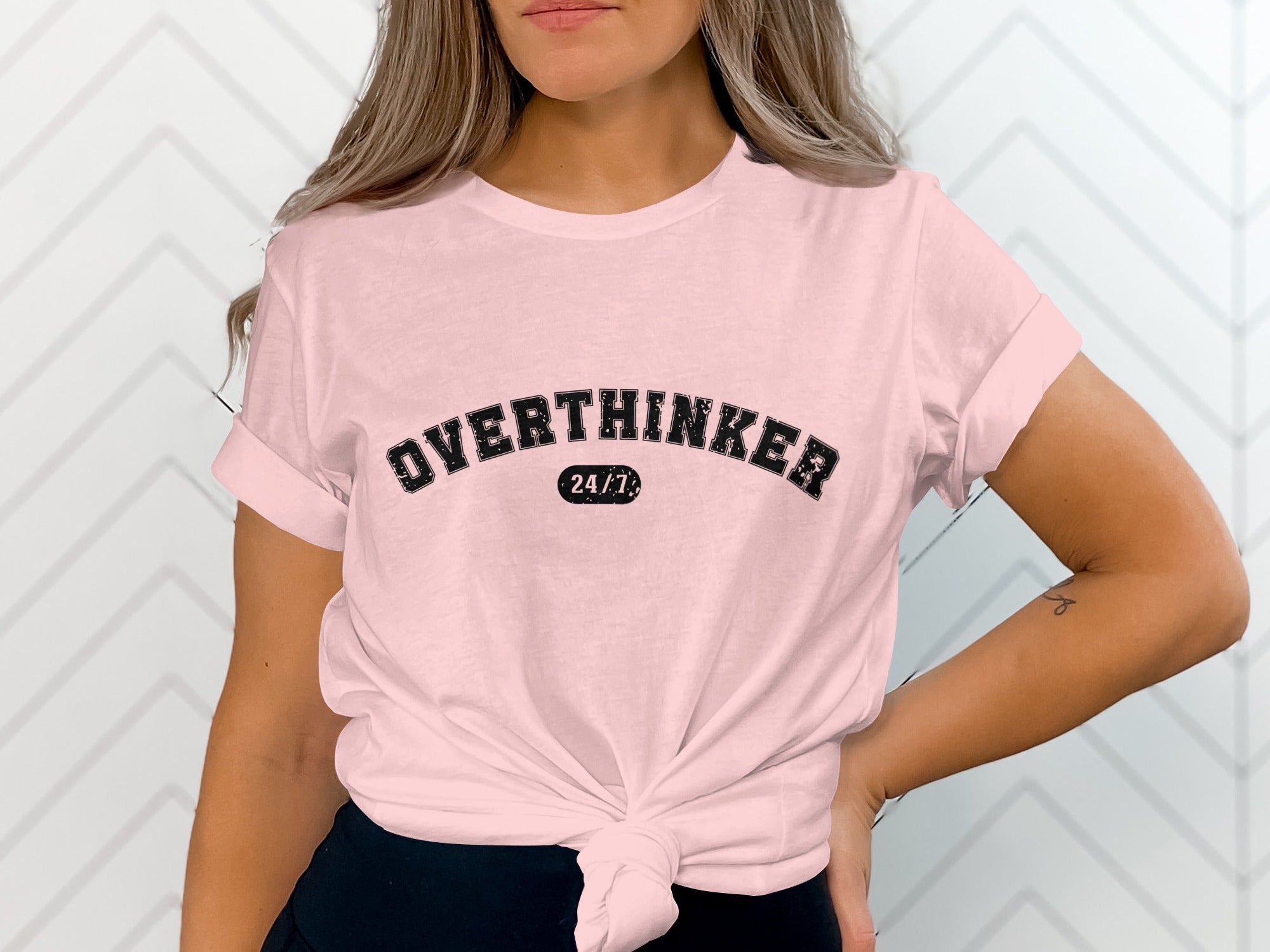 Pink t-shirt with "OVERTHINKER 24/7" text graphic